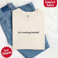 He’s Watching Football Tee - Comfort Colors Funny Shirt for Her